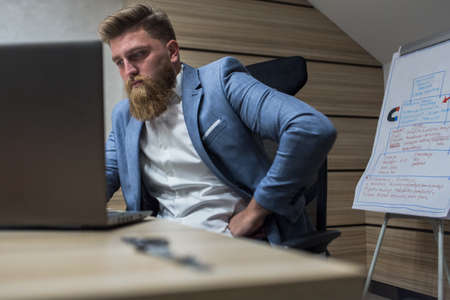 Businessman in office late night work on laptopの写真素材
