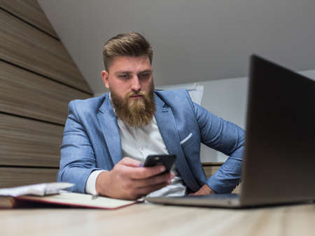 Businessman in office late night work on laptopの写真素材