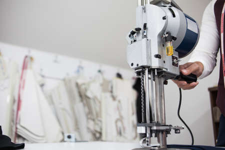 Young bearded tailor working on new cloting designの写真素材