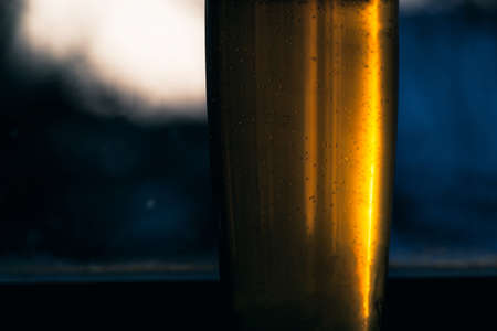 Cold glass of blonde beerの写真素材