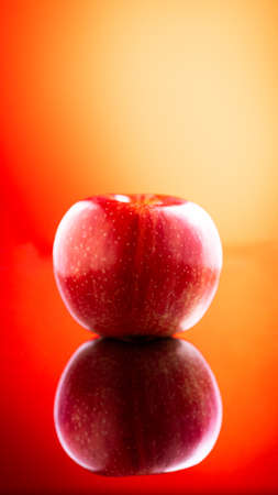 Large fresh red apple on red background gala schnico brookfield mema devil mustの写真素材