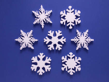 Christmas background with paper snowflake with soft shadows on light blue backgroundの写真素材