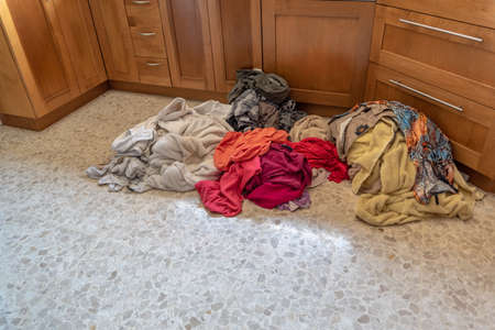 A series of pictures showing the piles of clothes disappearing as the loads of laundry get doneの写真素材