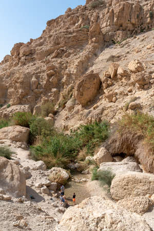 People hiking in beautiful scenic Ein Gedi National Park in southern Israel near the Dead Sea
