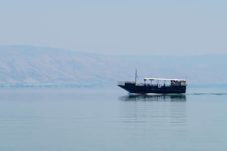 Sea of Galilee, Israel May 18, 2022 Tourist boat on the Sea of Galilee on a hazy Spring day.