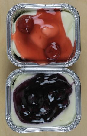 Minicherry cheesecakeminiblueberry cheesecake and chocolate biscuits in foil tray