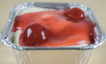 Minicherry cheesecake and chocolate biscuits in foil trayの写真素材