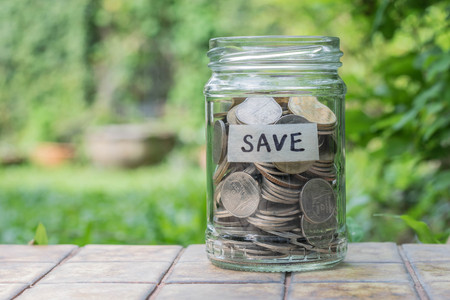 Coins in  a glass bottle(saving concept)の写真素材
