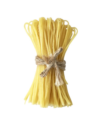 stack of raw spaghetti isolated on white backgroundの写真素材