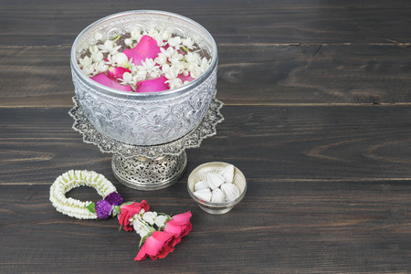 Thai garland Flowers and Water with jasmine and roses corolla in bowl(Songkran festival)の写真素材