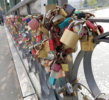 Tourist attraction, putting promise locks on side of bridge and throwing away key in river - Iron Bridge, Frankfurt, Germany, 4/13/2019の写真素材