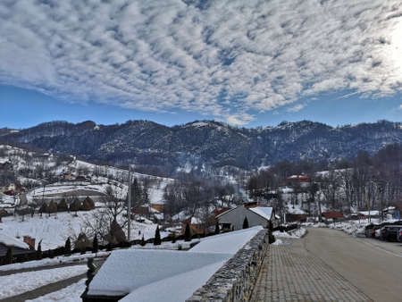 Photo of mountains in Romania, snowy landscape with cloud formations , blue sky and the Carpathian mountain range in Ponoarele, Mehedinti - 01/01/2019のeditorial素材