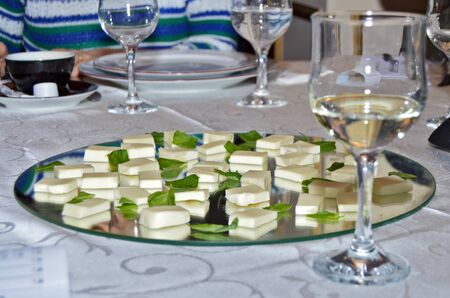 Elegant setting at restaurant table, close up shot of white wine glasses ready for tasting next to...