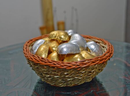 Wicker bowl decorative item filled with various shiny stones, interior decor ideas for massage parlor, great for oriental therapy sessionsの写真素材