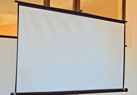 Clear blank projector sheet, business meeting whiteboard for video projecting, blank projections indoor for meeting rooms, clean white screenの写真素材