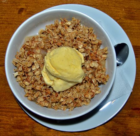 Top view of white bowl on table filled with tasty oats prepared by chef with vanilla ice cream on top, gread dessert ideas that are healthy and deliciousの写真素材