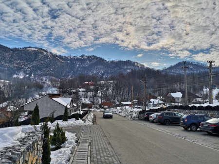 Landscape in the Romanian part of the Carpathian Mountain range, snowy peaks and cloud formations over Ponoarele village in Mehedinti, Romania - 01/01/2019のeditorial素材