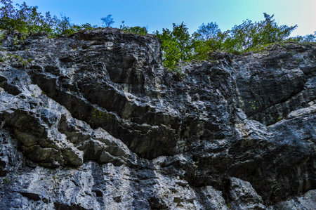 A river eroded a stone wall rock formation, Sohodol Gorges are full of unexplored caves. Carpathia, Romania.の写真素材