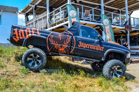 Jagermeister Truck advertising pickup-truck with black and orange brand label, parked in front of a bar at Vama Veche, Romania, July 2020のeditorial素材