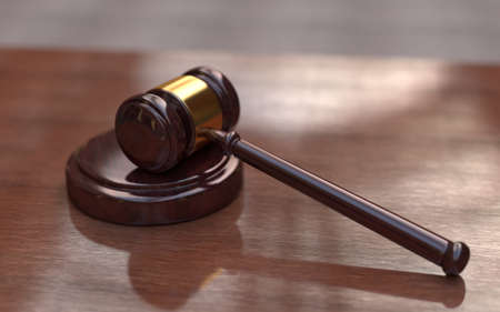 Judge, wooden gavel on the brown wooden background