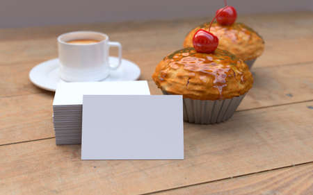 Red Cherry cupcakes on the brown wooden background with white, blank business cards. Mockupの写真素材