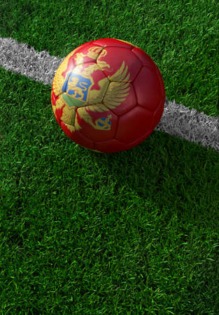 Soccer ball and national flag of Montenegro lies on the green grassの写真素材