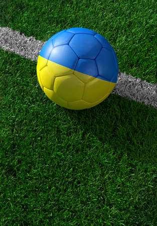 Soccer ball and national flag of Ukraine lies on the green grassの写真素材