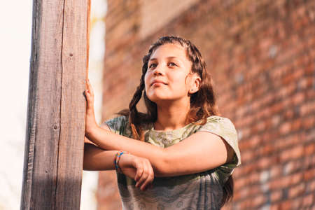 Portrait of beautiful attractive young sad woman has reflected on life at summer green parkの写真素材
