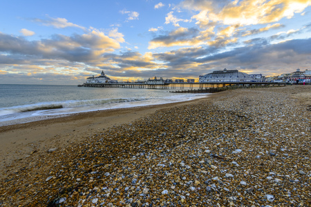 Eastbourne Pier and beach at sunset, East Sussex, England, UKの写真素材