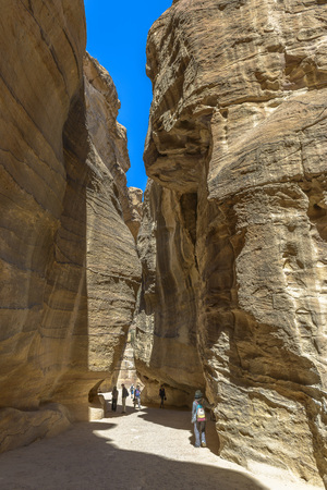 The Siq, the narrow canyon that serves as the entrance passage to the hidden city of Petra, Jordan.の写真素材