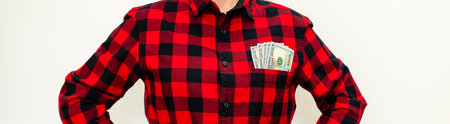 Dollar bills in the breast pocket of casual red shirt.の写真素材