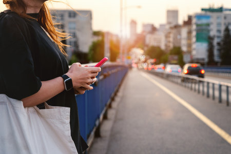 Female urban person with mobile phone in city.の写真素材