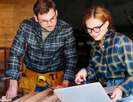 Local  business or startup. Adult couple works together in workshop. Projecting and planning.の写真素材