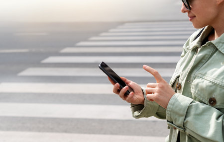 Using mobile phone in city. Urban lifestyle.の写真素材