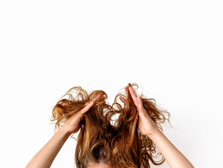 Brunette woman showing her damaged and dry hair.の写真素材