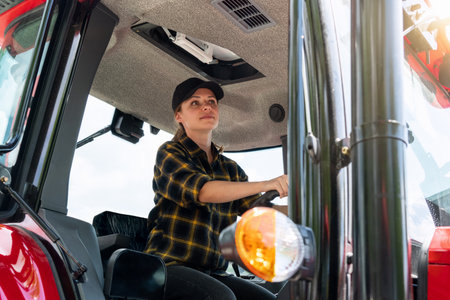 Woman working on a farm as a tractor driver