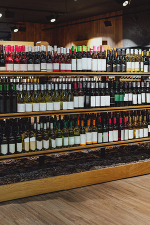 Wine bottles with blank labels on the retail display of liquor store.