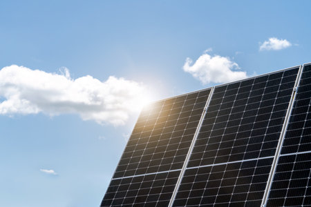 Photovoltaic plant. Solar panel and sunlight against blue sky.の写真素材