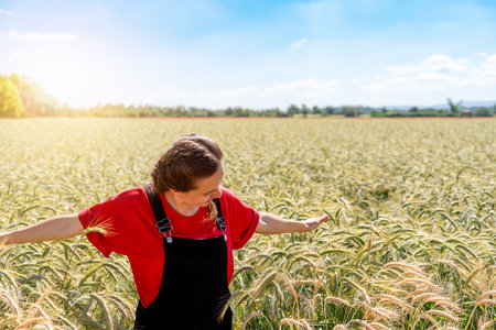 Happy young woman in wheat field on sunny summer dayの写真素材