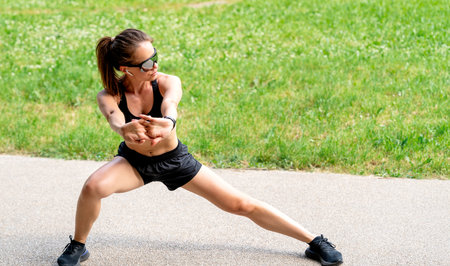 Concentrated fit woman warming up beforo street workout