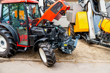 Farm tractor with lifted hood at dealership lot