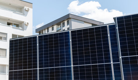 Solar station located in front of a residential building in the city.