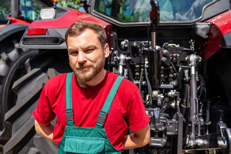 Portrait of rural man near tractor in countrysideの写真素材