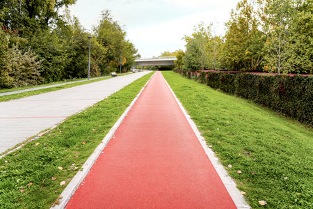 Red rubber recreational jogging path in city. Sports urban infrastructure.の写真素材