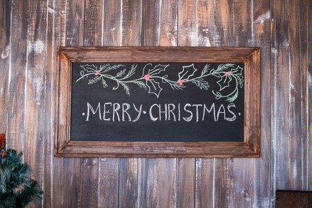 Merry Christmas, Christmas decoration with merry christmas on blackboard over wooden backgroundの写真素材