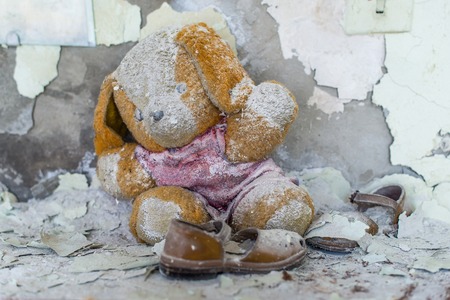 Abandoned kindergarten in Chernobyl Exclusion Zone. Lost toys, A broken doll. Atmosphere of fear and loneliness. Ukraine, ghost town Pripyat.の写真素材