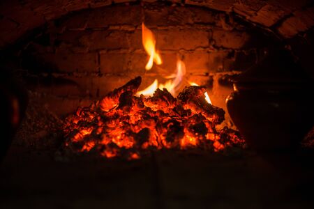 Village stove firewood and fire. Burning wood inside traditional ovenの写真素材