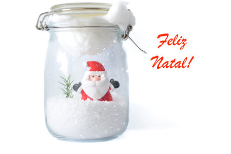 Santa Claus in snowy glass jar with Feliz Natal greeting on white background, festive Portuguese Christmas card design.の写真素材