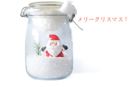 Santa Claus figure in snowy glass jar with Japanese Merry Christmas characters on white background, cute Asian holiday card.の写真素材