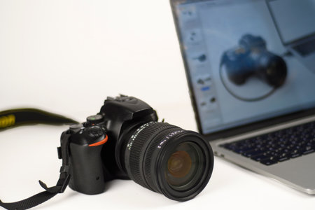 Professional photography setup with DSLR camera and laptop for editing and post-production. Clean...